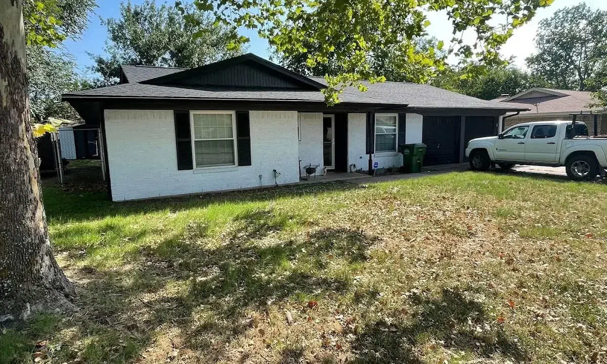 Professional roofing crew working on a residential roof in Wilson